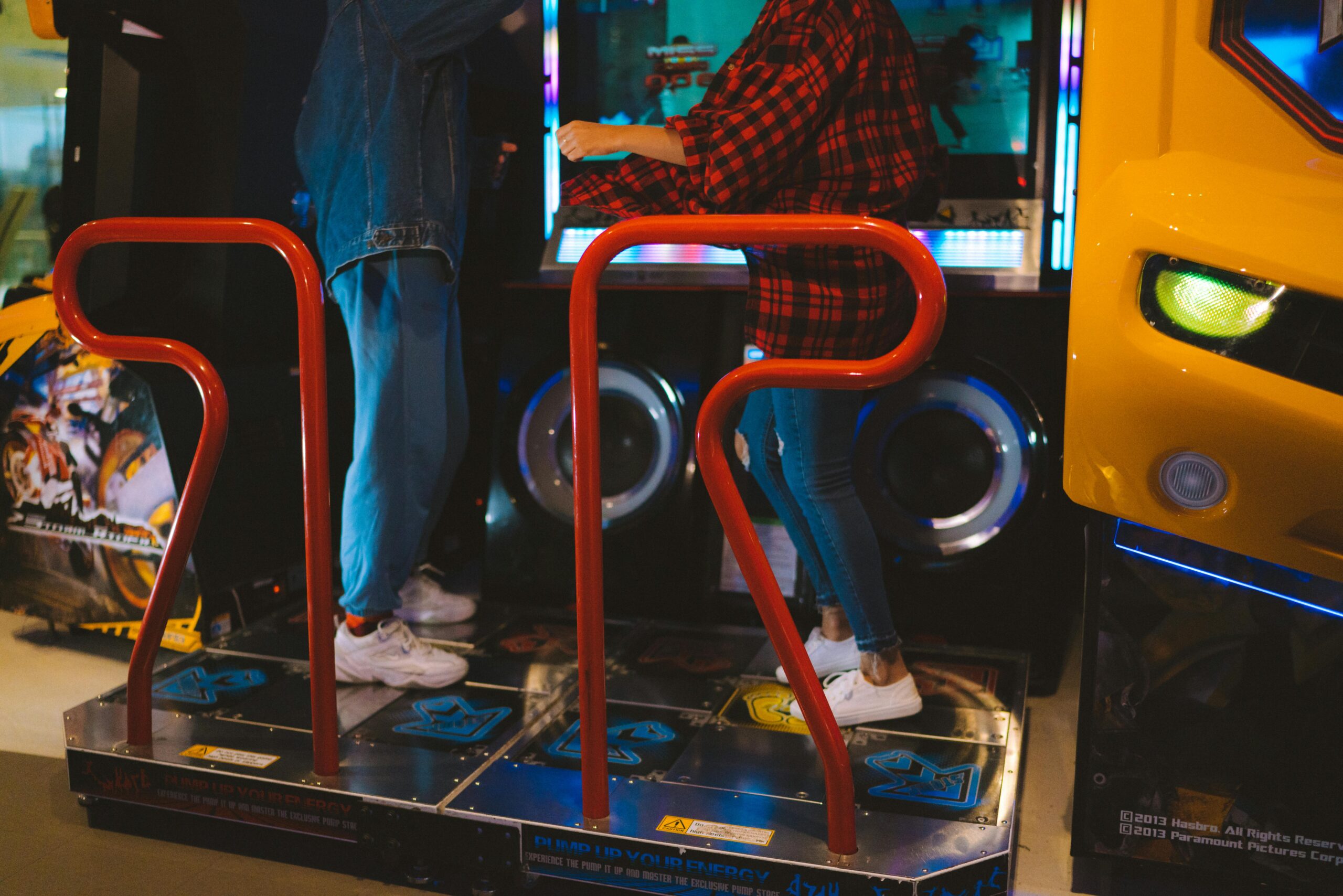pexels-photo-9833544-9833544 Adults having fun on a dance arcade game indoors. Vibrant, recreational, gaming fun.